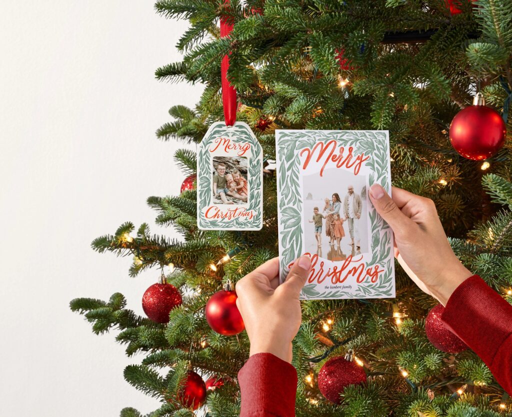 personalized christmas ornament hanging on a tree next to a christmas card