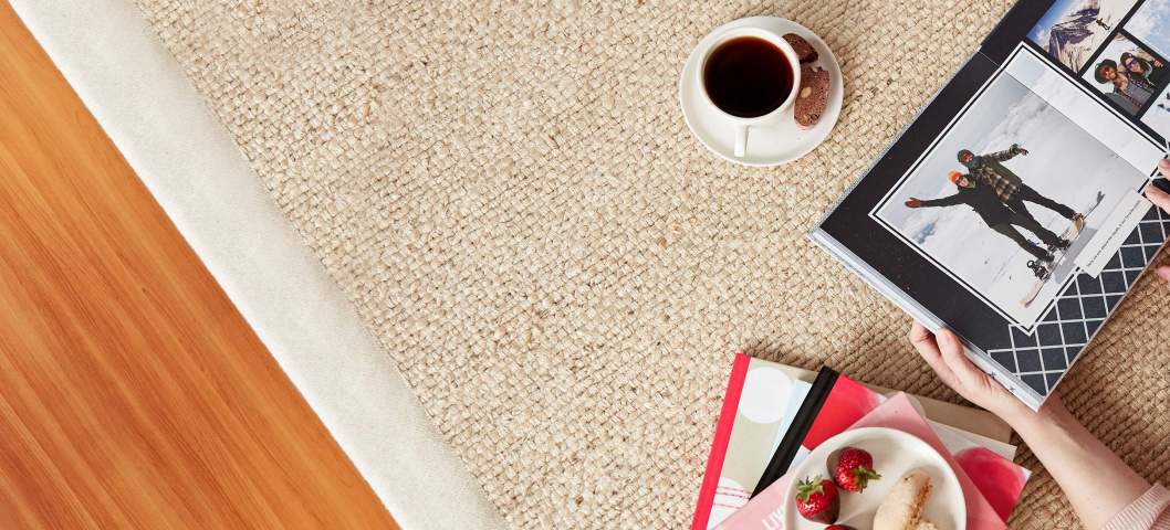 girl on floor looking at photo book