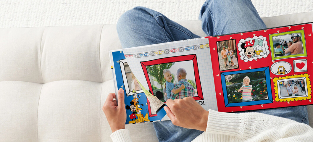 person flipping through a disney photo book