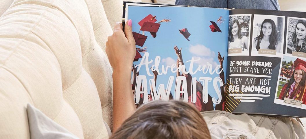 Girl looking through graduation photo book