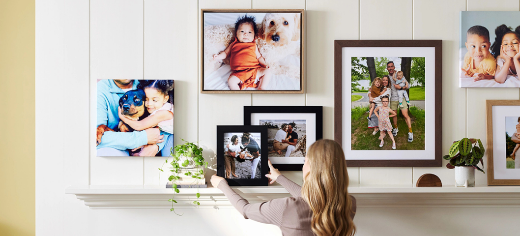 woman putting together a photo gallery wall